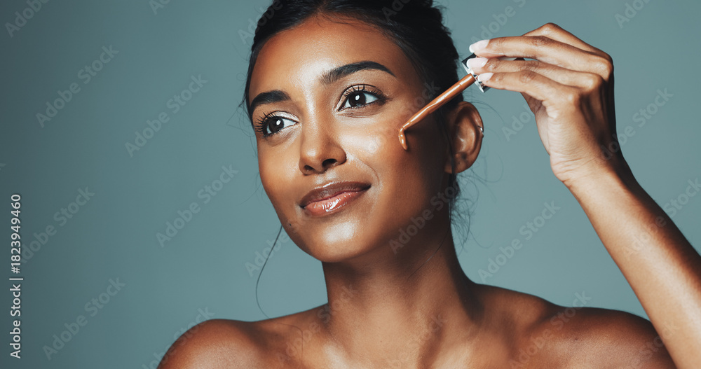 Obraz premium Beauty, makeup or woman with foundation dropper in studio, application or facial product for aesthetic. Even skin tone, space or happy person with natural cosmetic for glow, shine or green background