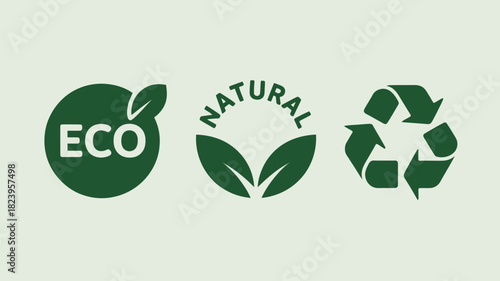 Three green ecological symbols including eco natural and recycling on a light background surface