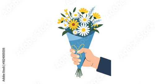 Human hand holds a beautiful bouquet of yellow and white daisy-like flowers wrapped elegantly in blue paper.