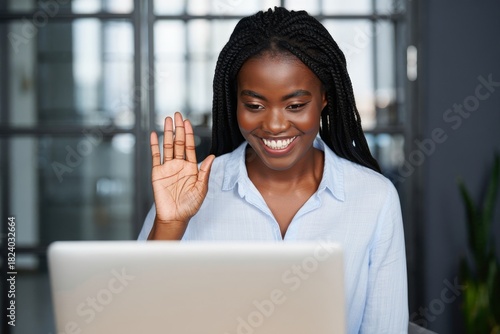 Smiling Young Woman Waving at Laptop Screen - Remote Communication and Connection