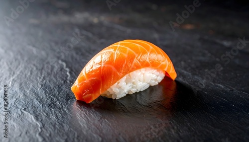 Fototapeta Naklejka Na Ścianę i Meble -  Nigiri de salmón fresco sobre pizarra negra en estilo gastronómico premium
