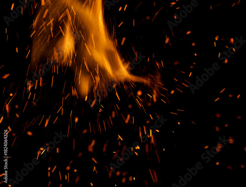 A fire is burning and the smoke is creating a lot of sparks