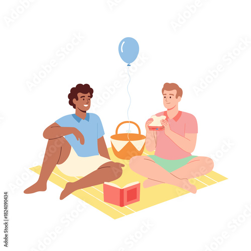 Two men enjoying picnic on blanket with basket and balloon 