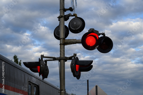 railroad crossing sign with red flashing light signal