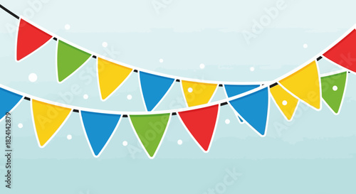 Colorful pennant banner string decoration against light blue sky