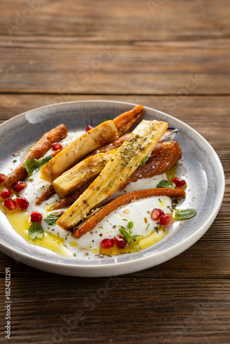 Close up of roasted carrot and parsnip yogurt  wooden surface healthy food