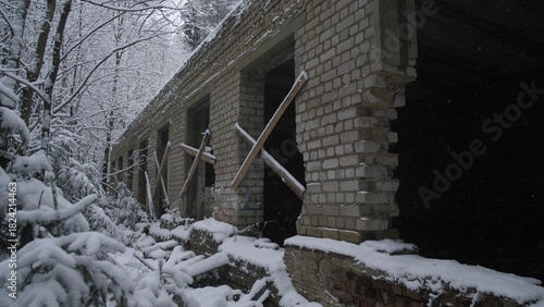 War Ukraine long brick corridor with snow outside, series of window openings framed by wooden braces, deep interior shadows and perspective lines, cold damp atmosphere, composition fit