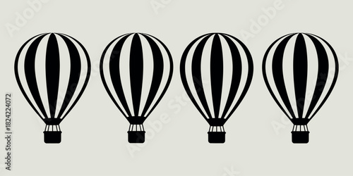 Four black and white striped hot air balloons in a row
