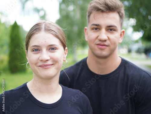 couple with dog, young  man with girl and with pomeranian spitz in the park portrait