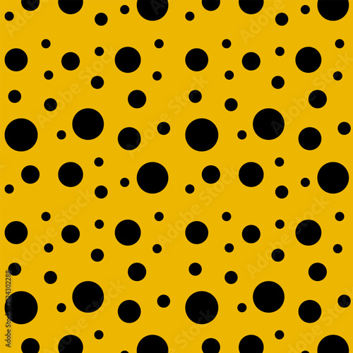 Black circles of different sizes on a yellow background.Vector seamless pattern with black circles on a yellow background.