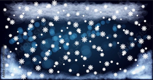 Snowflakes falling softly against a dark blue background with a hint of mist and clouds during a winter evening