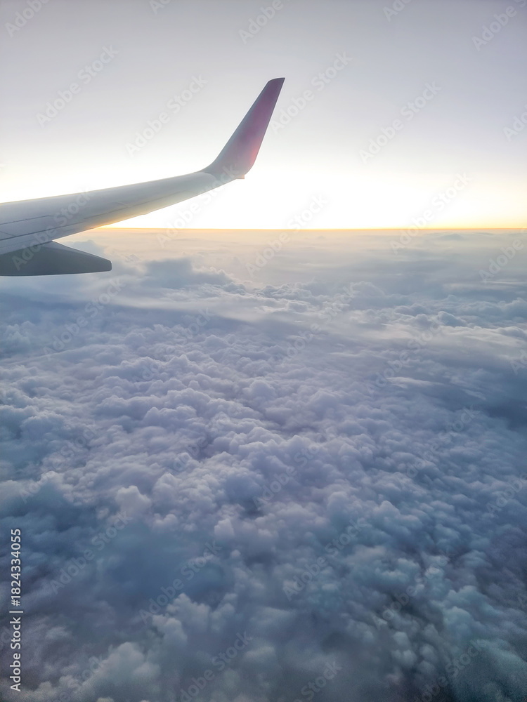 Obraz premium View from the window of an airplane wing high above the ground.