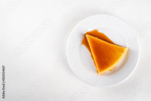 Traditional flan cake, Custard Tart or Flan Topped with Caramel sauce on white kitchen table copy space