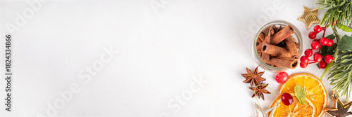 Winter autumn drink and food ingredients. Cranberries, sliced oranges, cinnamon, rosemary, anise for cooking cocktails, with christmas tree branches. Flatlay on white background. Top view copy space