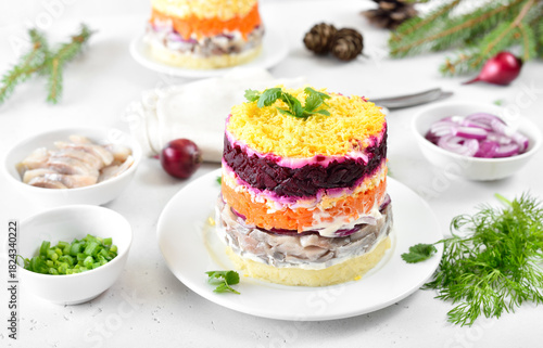 Layered salad with beet, herring, carrots and potatoes