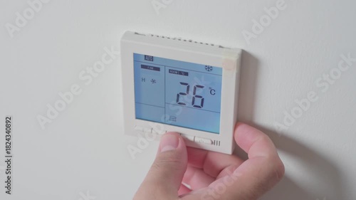 Adjust temperature at remote control with display for using air conditioner, close up. High quality 4k footage