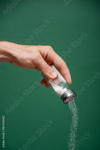 Hand Seasoning Food with Fine White Salt