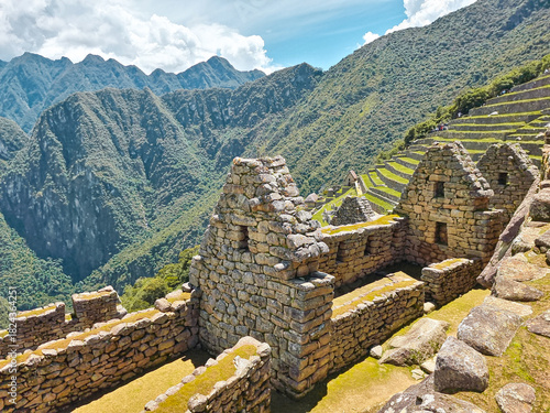 The ancient Inca city of Machu Picchu, nestled high in the Andes Mountains of Peru. The breathtaking view showcases the iconic terraces, stone ruins, and surrounding green peaks.