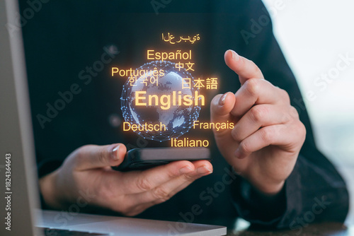 Display of languages and global communication through a smartphone at a workspace during daytime