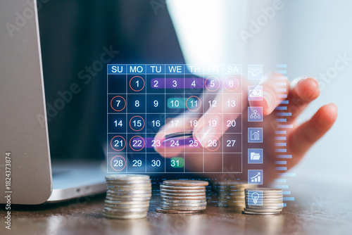 Digital financial planning with a calendar interface used by a person at a laptop