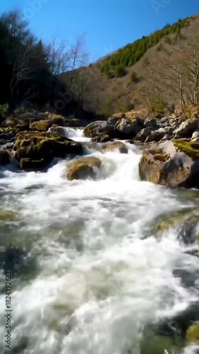 A river flowing swiftly between rocks.