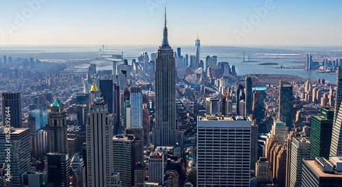 Aerial view of new york city skyline featuring the empire state building and surrounding skyscrapers on a clear day