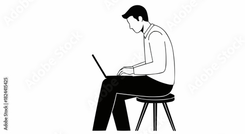 Man working on laptop sitting on stool focused and concentrated.