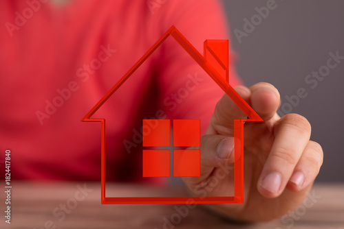 Hand featuring house outlin...