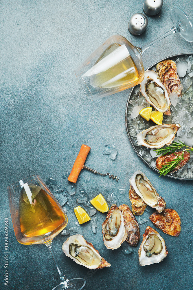 Fototapeta premium Fresh oysters with glasses of sparkling wine. Healthy sea food. Top view. Free space for text.