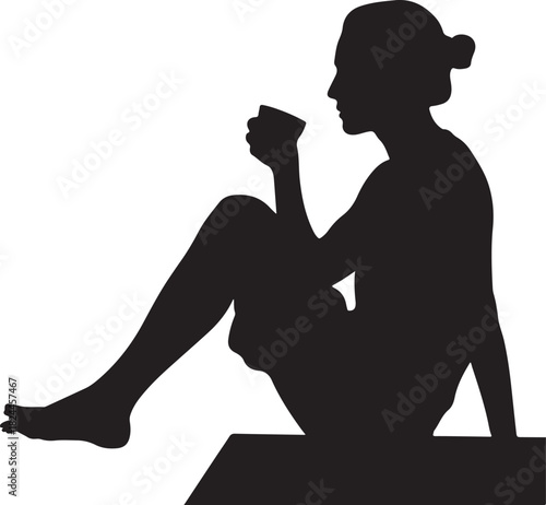Silhouette of a woman sitting and drinking from a cup