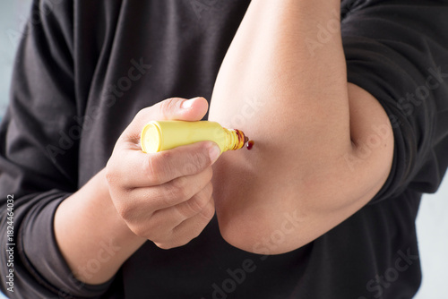 Obraz na płótnie Hand Holding Povidone Iodine Bottle for First Aid Treatment