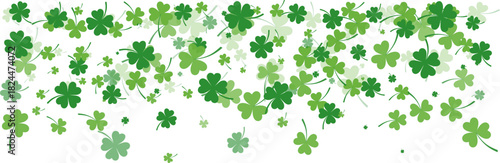 Numerous green shamrocks and four-leaf clovers in various shades falling against a clean white backdrop, symbolizing luck and St. Patrick's Day.