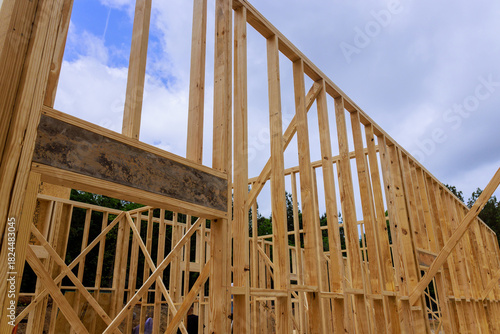 Wooden framing of building is being constructed, beams timber framework construction