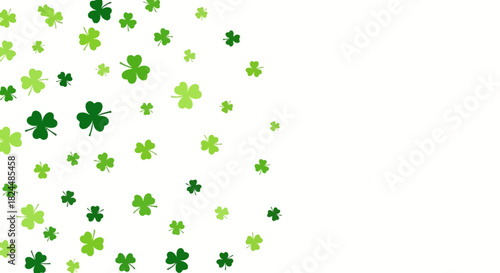 A white background with a scattering of various green shamrocks and clovers on the left side, suitable for St. Patrick's Day.