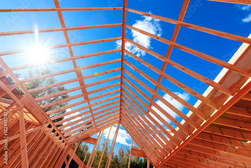 Canvas-taulu New wooden beams are being installed on rafters to installed house under constru