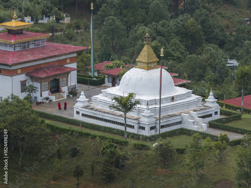 Aerial view of the Sangchhen Dorji Lhuendrup Lhakhang Nunnery complex showcasing the contrast of white stupas against verdant hills, Walakha, Punakha, Bhutan.