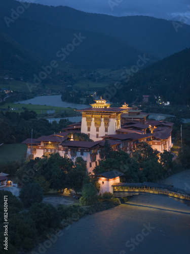 Wallpaper Mural Aerial view of the majestic Punakha Dzong, a fortress illuminated against the twilight, with a river flowing beneath, Punakha, Punakha, Bhutan. Torontodigital.ca