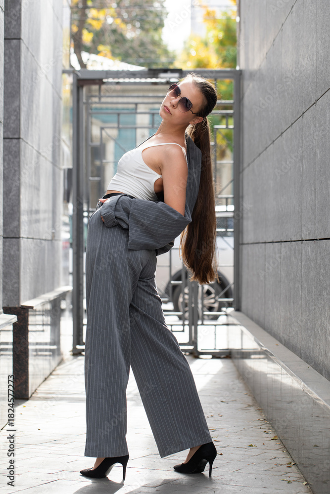 Obraz premium A businesswoman poses in a pantsuit