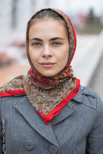 Portrait of a young beautiful woman with a scarf on her head