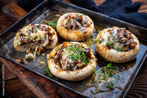 Konstfotografi Portabello mushrooms stuffed with cheese and fresh herbs, oven baked with raclet