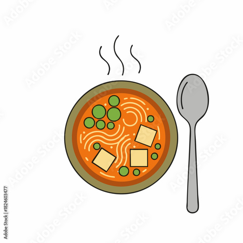 Hot bowl of delicious ramen soup with noodles peas and tofu next to a spoon.