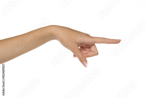 Studio close-up of female hand with natural manicure pointing with index finger to the side on white background.