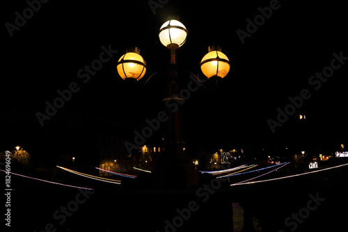 Old fashioned street lights over the river cart at Christmas