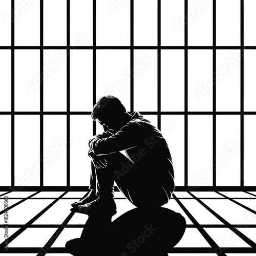 Silhouette of a person sitting alone in a prison cell