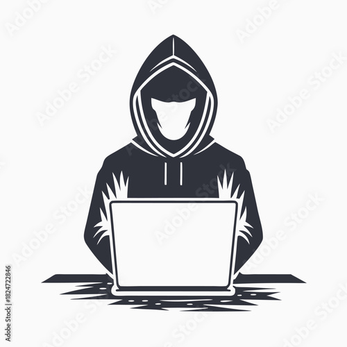 Dark silhouette of a hooded figure is seen using laptop at a desk