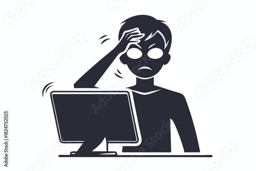 Frustrated man stares at a computer screen while holding his head in despair