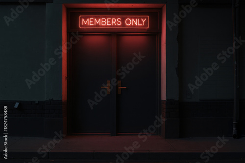 Members only door with red neon. Private club entrance with glowing frame. Urban architecture exterior with dark wall.