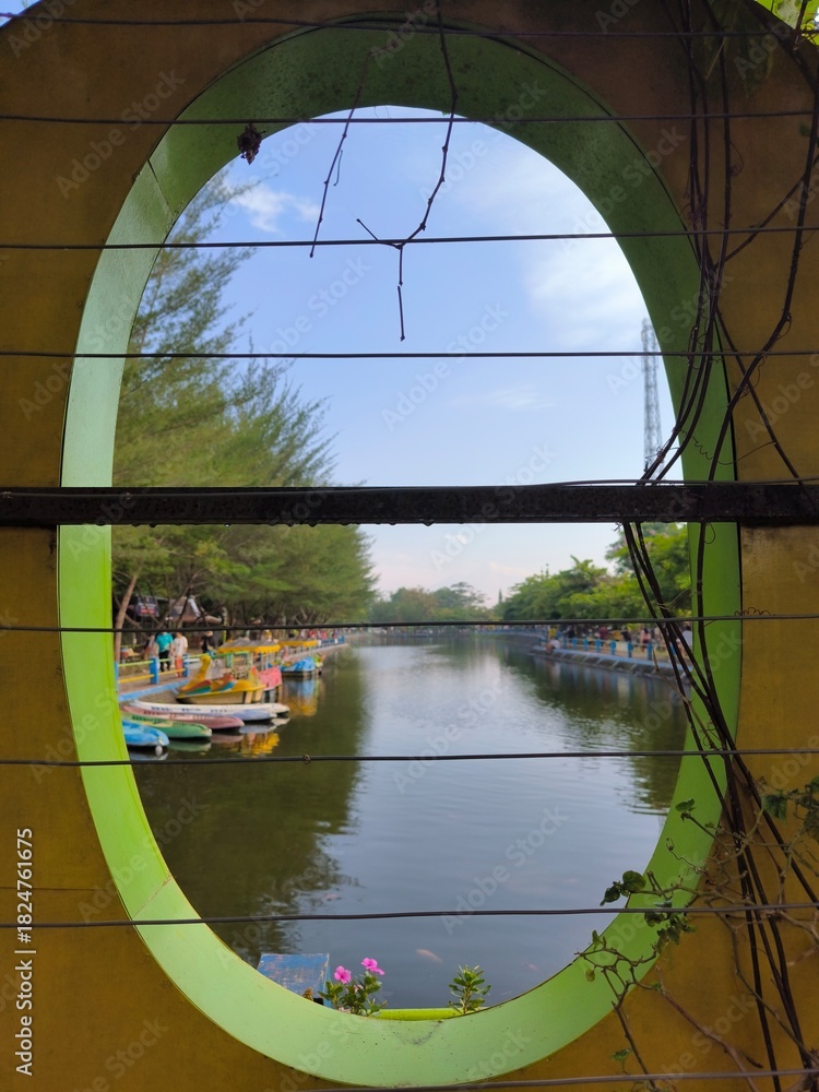 Fototapeta premium View of the tourist lake from an oval window.