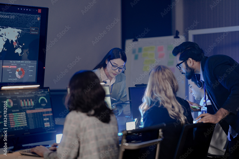 Obraz premium Dynamic night ops hub action Diverse team collaborates intensely analyzing critical data screens leader provides guidance modern command center buzz achieves mission goals now teamwork boost.