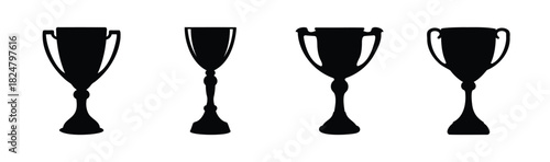 Set of four black trophy and award cup silhouettes isolated